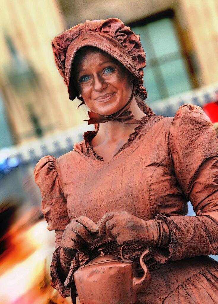 Miss Copper Kettle is a Victorian, realistic-looking human statue and theatre act suitable for family-friendly, food-themed, history-themed and Victorian events.